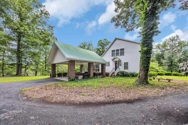 3231 Center Rd, Georgetown, SC 29440 - view of front of property featuring metal roof, brick siding, and driveway