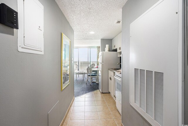 300 N Ocean Blvd Unit 723, North Myrtle Beach, SC 29582 - hall with electric panel, a textured ceiling, light tile patterned floors, baseboards, and a heating unit