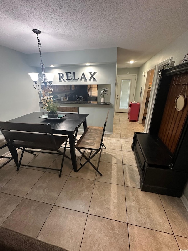 201 Hillside Dr N Unit 111, North Myrtle Beach, SC 29582 - dining area with a textured ceiling, light tile patterned flooring, and a chandelier