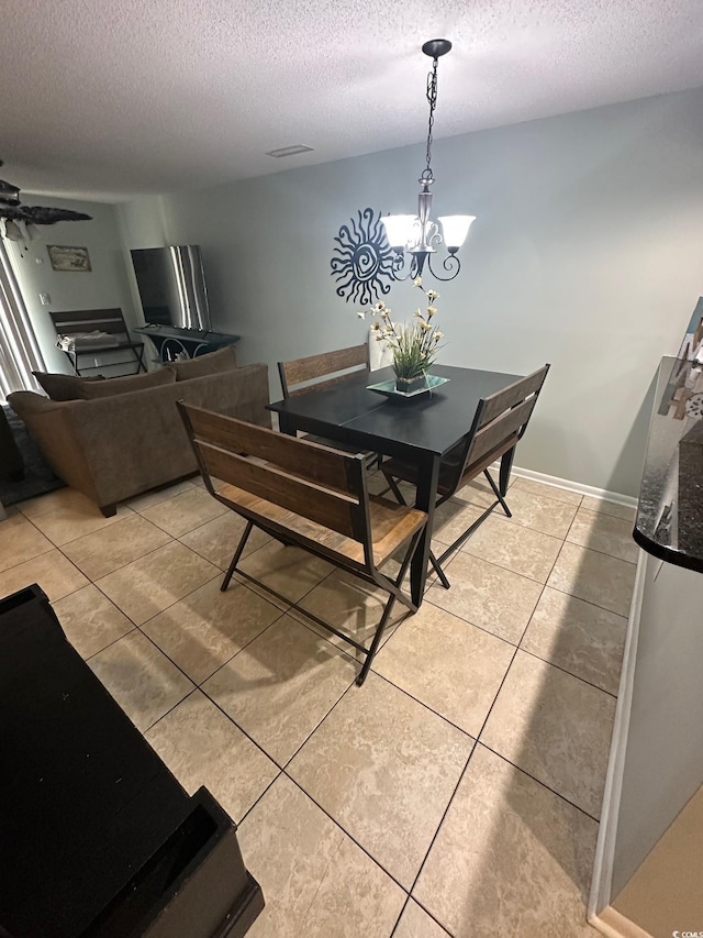 201 Hillside Dr N Unit 111, North Myrtle Beach, SC 29582 - dining room with a textured ceiling, light tile patterned flooring, a ceiling fan, and a chandelier