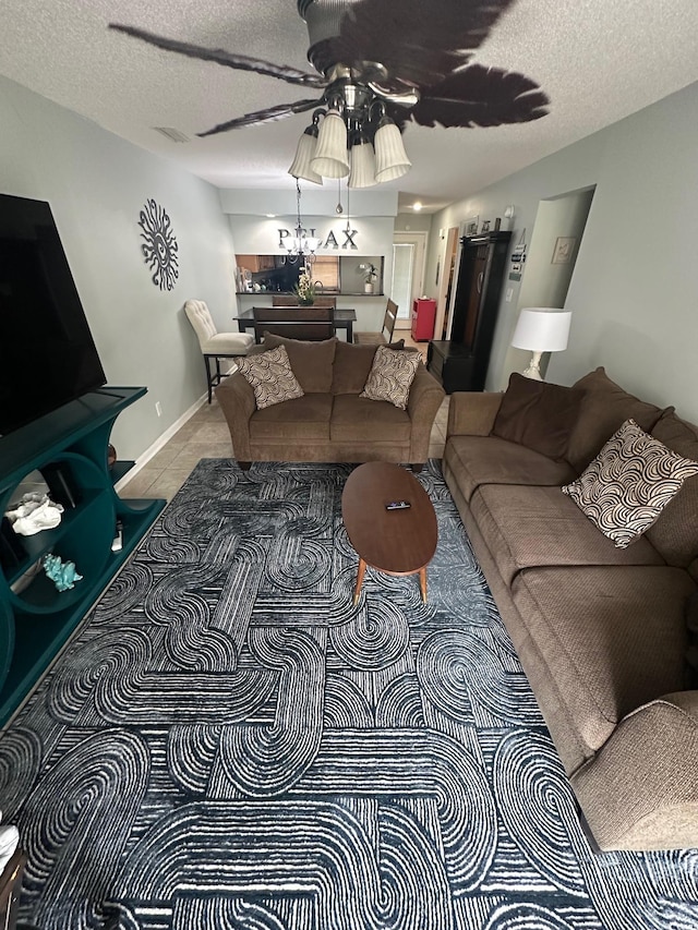 201 Hillside Dr N Unit 111, North Myrtle Beach, SC 29582 - tiled living area with a ceiling fan, a textured ceiling, and baseboards