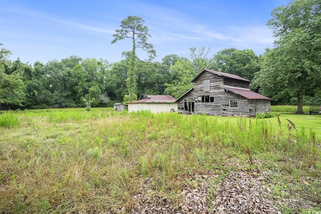 1731 Lee Ln, Longs, SC 29568 - view of yard featuring a barn, an outdoor structure, and a view of trees