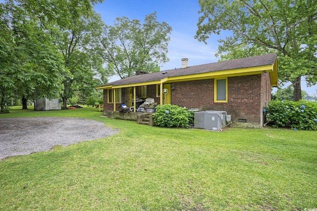 1731 Lee Ln, Longs, SC 29568 - rear view of property featuring central AC unit, brick siding, a lawn, and crawl space