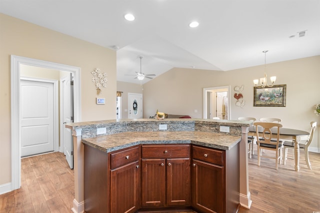 177 Baylee Cir, Galivants Ferry, SC 29544 - kitchen with light wood-style flooring, vaulted ceiling, pendant lighting, a ceiling fan, and light countertops