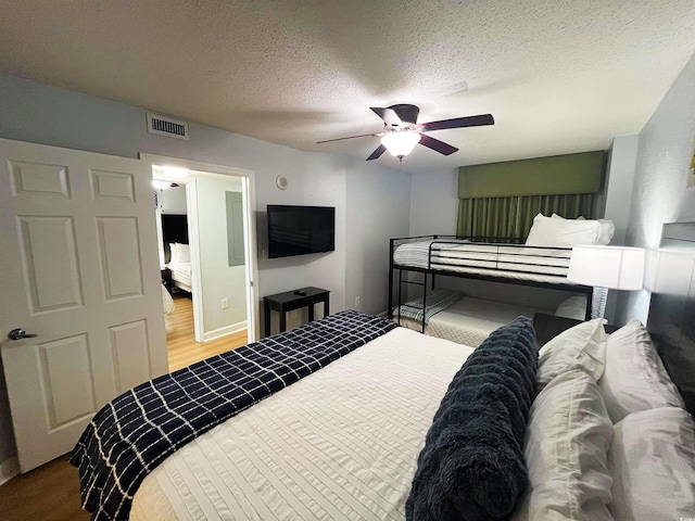 2007 S Ocean Blvd Unit 1506, Myrtle Beach, SC 29577 - bedroom with a textured ceiling, wood finished floors, a ceiling fan, and baseboards