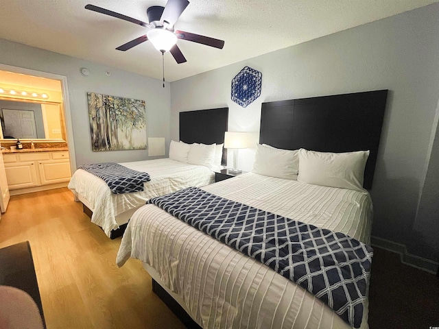 2007 S Ocean Blvd Unit 1506, Myrtle Beach, SC 29577 - bedroom featuring light wood finished floors, ensuite bathroom, ceiling fan, and a sink