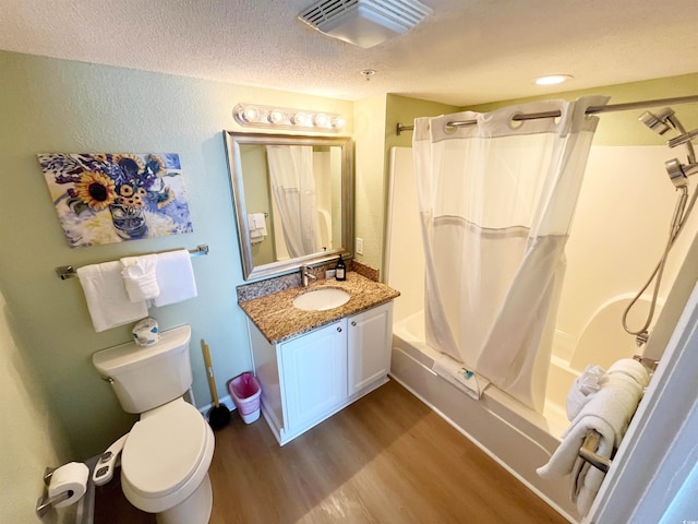 2007 S Ocean Blvd Unit 1506, Myrtle Beach, SC 29577 - bathroom featuring toilet, wood finished floors, shower / bath combo, vanity, and a textured ceiling