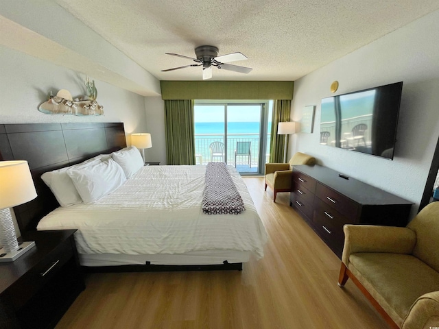 2007 S Ocean Blvd Unit 1506, Myrtle Beach, SC 29577 - bedroom with light wood-style floors, access to outside, a textured ceiling, and ceiling fan