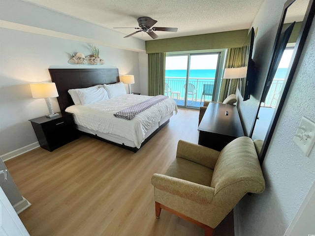 2007 S Ocean Blvd Unit 1506, Myrtle Beach, SC 29577 - bedroom featuring access to outside, wood finished floors, a textured ceiling, a ceiling fan, and baseboards