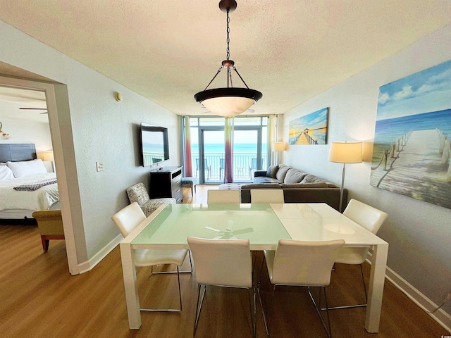 2007 S Ocean Blvd Unit 1506, Myrtle Beach, SC 29577 - dining room with wood finished floors, baseboards, and a textured ceiling