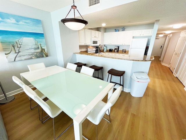 2007 S Ocean Blvd Unit 1506, Myrtle Beach, SC 29577 - dining room featuring light wood-style flooring and baseboards
