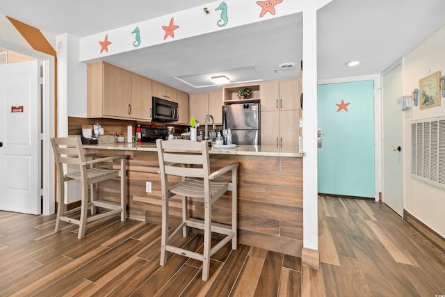 9820 Queensway Blvd Unit 502, Myrtle Beach, SC 29572 - kitchen featuring freestanding refrigerator, light brown cabinets, black microwave, wood finished floors, and open shelves