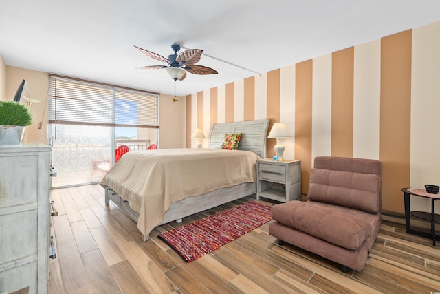 9820 Queensway Blvd Unit 502, Myrtle Beach, SC 29572 - bedroom with wallpapered walls, wood finished floors, and a ceiling fan