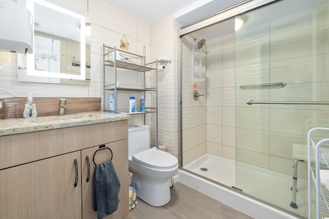 9820 Queensway Blvd Unit 502, Myrtle Beach, SC 29572 - bathroom featuring toilet, a shower stall, vanity, and water heater