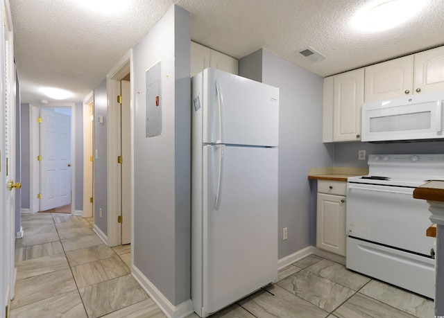 1100 Possum Trot Dr Unit D106, North Myrtle Beach, SC 29582 - kitchen featuring white appliances, light marble finish flooring, a textured ceiling, white cabinets, and light countertops