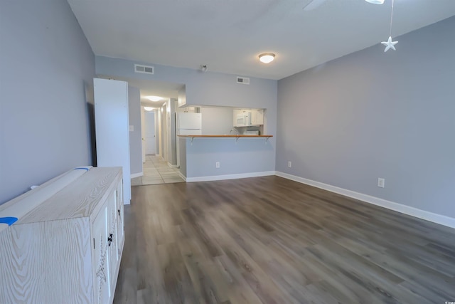 1100 Possum Trot Dr Unit D106, North Myrtle Beach, SC 29582 - unfurnished living room with wood finished floors and baseboards