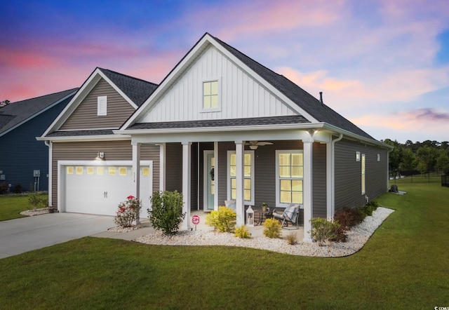 314 Bumble Cir, Murrells Inlet, SC 29576 - view of front of house featuring board and batten siding, a porch, a front yard, driveway, and roof with shingles