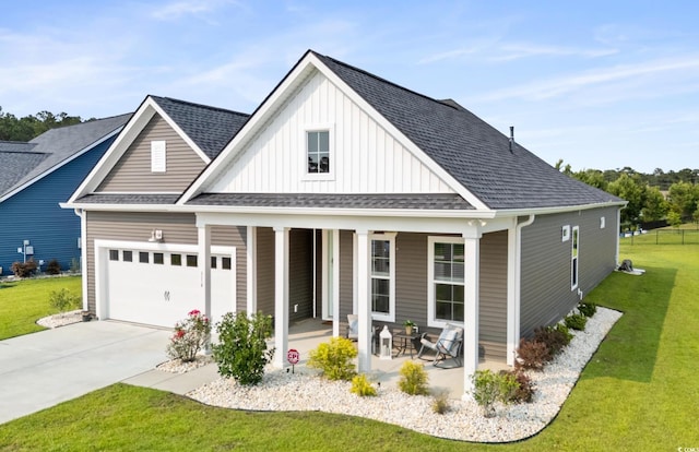 314 Bumble Cir, Murrells Inlet, SC 29576 - view of front of property with a porch, board and batten siding, a front yard, driveway, and a garage