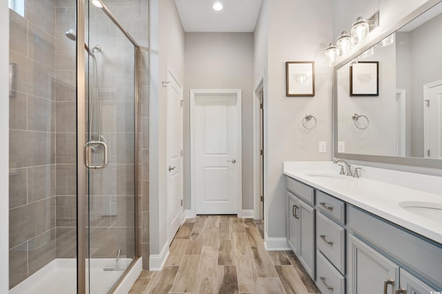314 Bumble Cir, Murrells Inlet, SC 29576 - bathroom with double vanity, a shower stall, recessed lighting, and wood finished floors