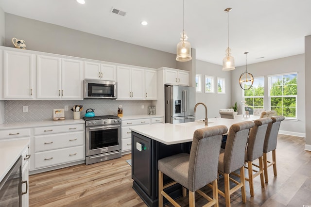 314 Bumble Cir, Murrells Inlet, SC 29576 - kitchen featuring high quality appliances, a breakfast bar area, tasteful backsplash, light wood-style flooring, and recessed lighting