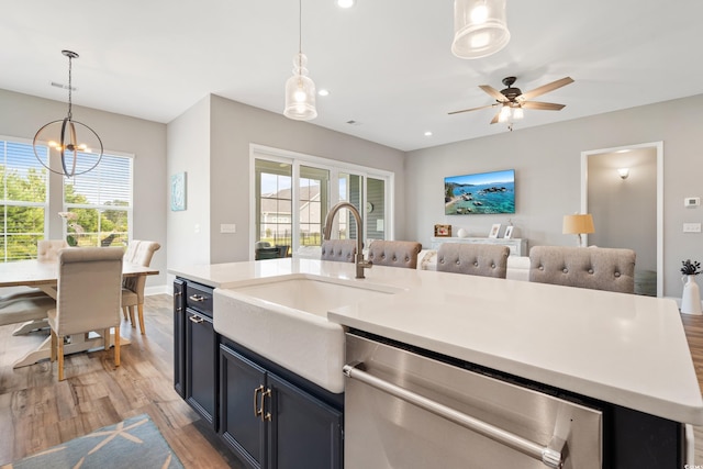 314 Bumble Cir, Murrells Inlet, SC 29576 - kitchen featuring stainless steel dishwasher, open floor plan, light wood finished floors, light countertops, and healthy amount of natural light