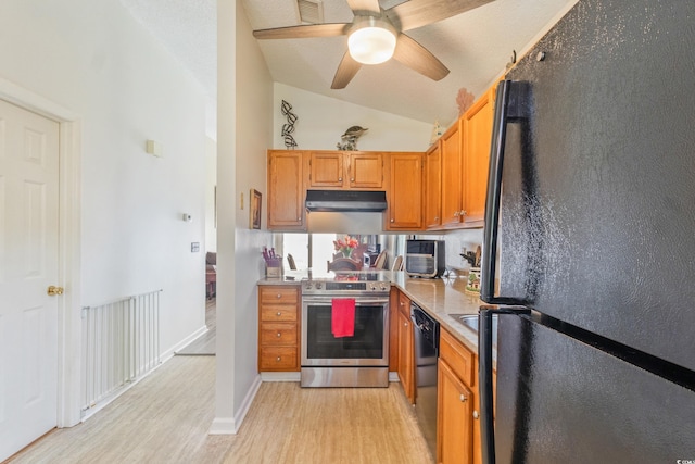 1407 Sunningdale Ln, Myrtle Beach, SC 29588 - kitchen with black appliances, under cabinet range hood, light wood finished floors, vaulted ceiling, and light countertops