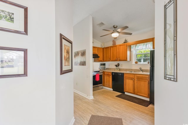 1407 Sunningdale Ln, Myrtle Beach, SC 29588 - kitchen with black appliances, light wood-type flooring, light countertops, under cabinet range hood, and ceiling fan
