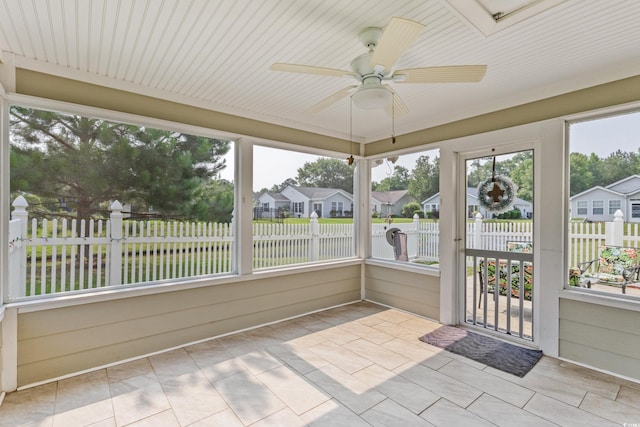 1407 Sunningdale Ln, Myrtle Beach, SC 29588 - unfurnished sunroom featuring a ceiling fan, a residential view, and tile patterned floors
