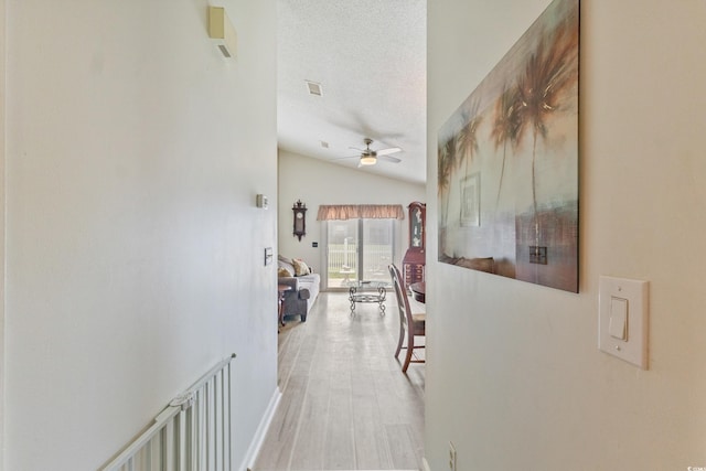 1407 Sunningdale Ln, Myrtle Beach, SC 29588 - hall with lofted ceiling, wood finished floors, and a textured ceiling