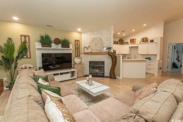 108 Pipers Ln Unit 108, Myrtle Beach, SC 29575 - living room with a large fireplace, recessed lighting, light wood-style floors, and high vaulted ceiling