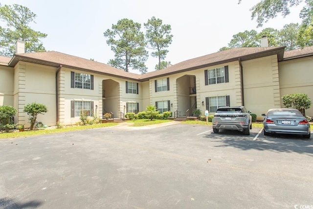 108 Pipers Ln Unit 108, Myrtle Beach, SC 29575 - view of building exterior featuring uncovered parking
