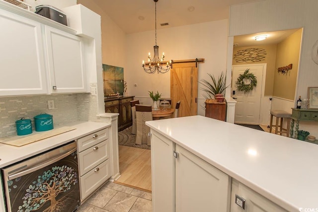 108 Pipers Ln Unit 108, Myrtle Beach, SC 29575 - kitchen featuring wine cooler, a barn door, backsplash, a chandelier, and white cabinets