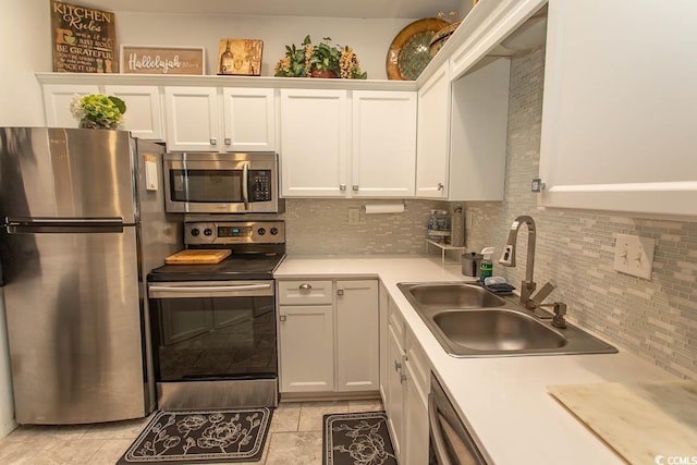 108 Pipers Ln Unit 108, Myrtle Beach, SC 29575 - kitchen featuring appliances with stainless steel finishes, a sink, decorative backsplash, and white cabinetry