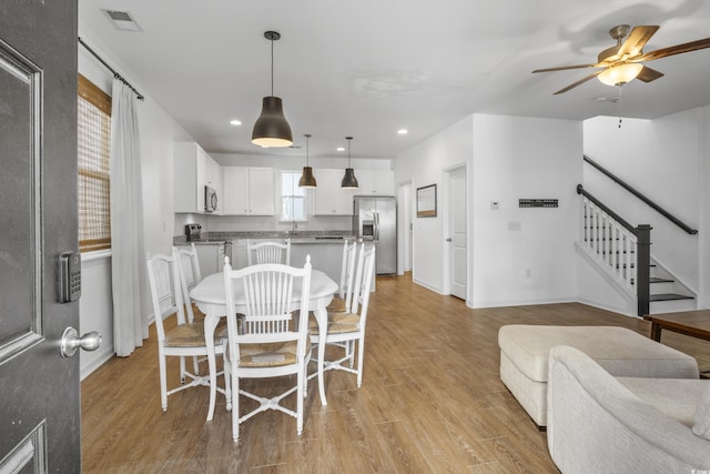 3547 Ladybank Loop, Myrtle Beach, SC 29577 - dining area featuring light wood-style flooring, a ceiling fan, stairway, baseboards, and recessed lighting