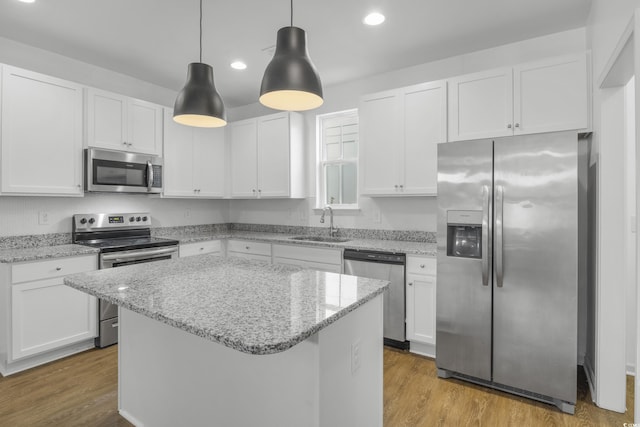 3547 Ladybank Loop, Myrtle Beach, SC 29577 - kitchen with stainless steel appliances, a sink, white cabinets, wood finished floors, and recessed lighting