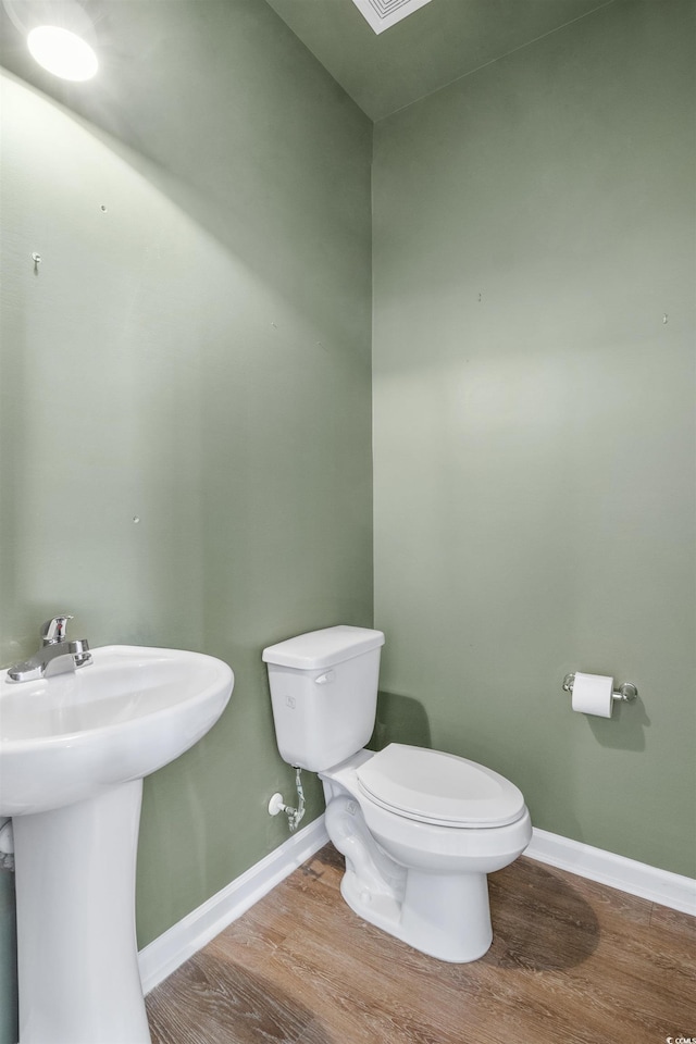 3547 Ladybank Loop, Myrtle Beach, SC 29577 - half bathroom featuring toilet, wood finished floors, baseboards, and a sink