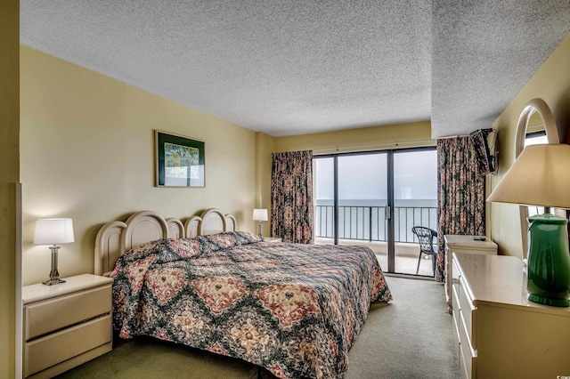 912 N Waccamaw Dr Unit 904, Garden City Beach, SC 29576 - bedroom with access to exterior, carpet, a textured ceiling, and a water view