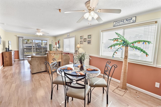 4350 Intercoastal Dr Unit 1101, Little River, SC 29566 - dining space featuring a ceiling fan, a textured ceiling, light wood finished floors, baseboards, and crown molding