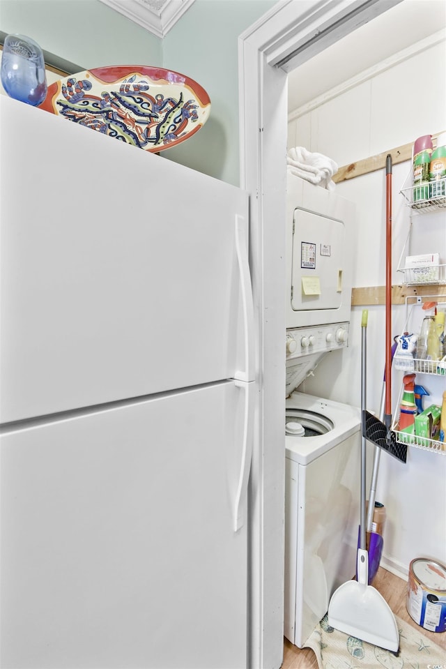 4350 Intercoastal Dr Unit 1101, Little River, SC 29566 - laundry room with stacked washer / dryer, wood finished floors, and crown molding