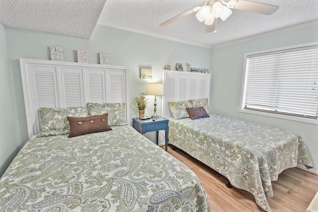 4350 Intercoastal Dr Unit 1101, Little River, SC 29566 - bedroom with wood finished floors, a textured ceiling, ornamental molding, and a ceiling fan