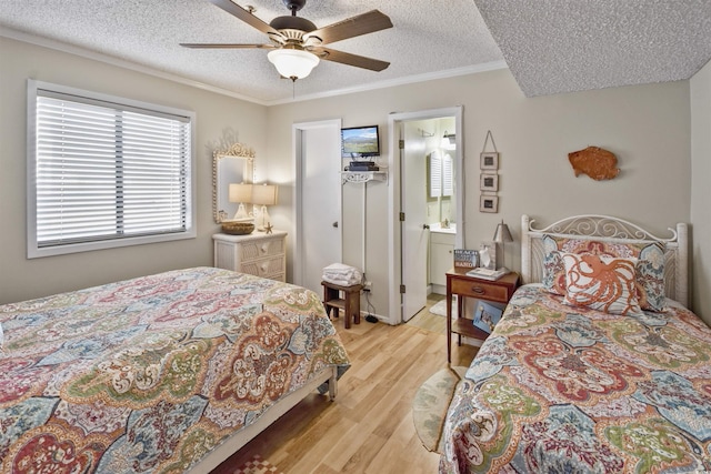 4350 Intercoastal Dr Unit 1101, Little River, SC 29566 - bedroom featuring a textured ceiling, light wood-style flooring, crown molding, a ceiling fan, and a spacious closet