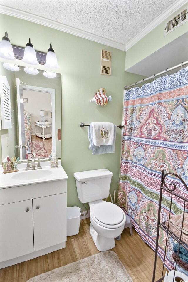 4350 Intercoastal Dr Unit 1101, Little River, SC 29566 - bathroom with crown molding, wood finished floors, vanity, toilet, and a textured ceiling