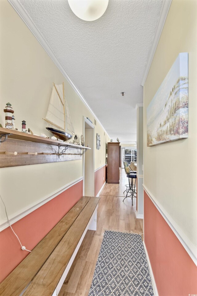 4350 Intercoastal Dr Unit 1101, Little River, SC 29566 - hall featuring ornamental molding, wood finished floors, and a textured ceiling