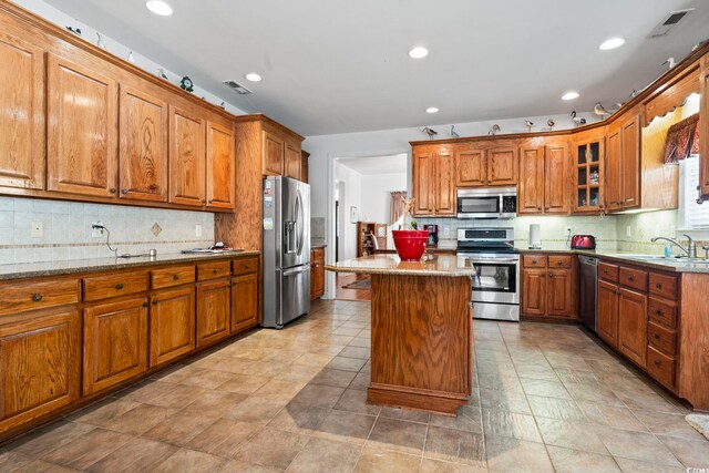 1044 Martin Ln, Conway, SC 29526 - kitchen with appliances with stainless steel finishes, brown cabinets, tasteful backsplash, and recessed lighting