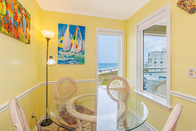 4525 S Ocean Blvd Unit 406, North Myrtle Beach, SC 29582 - tiled dining space with crown molding, wainscoting, a decorative wall, and a water view