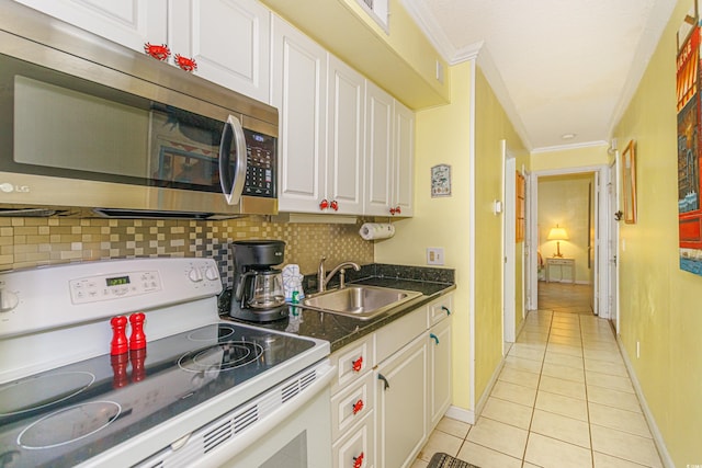 4525 S Ocean Blvd Unit 406, North Myrtle Beach, SC 29582 - kitchen with electric stove, stainless steel microwave, a sink, light tile patterned floors, and white cabinets