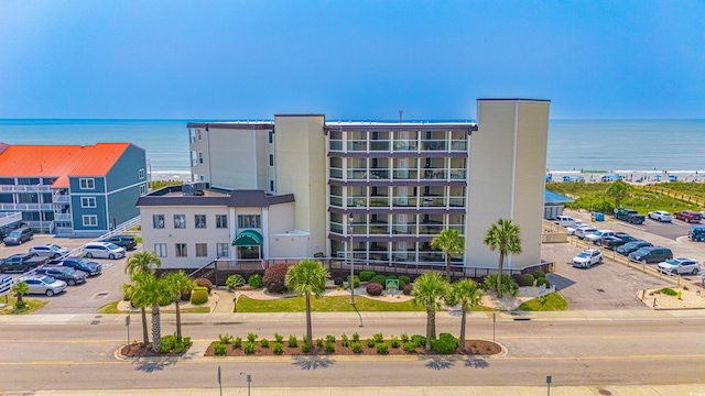 4525 S Ocean Blvd Unit 406, North Myrtle Beach, SC 29582 - view of apartment building / complex featuring uncovered parking and a water view