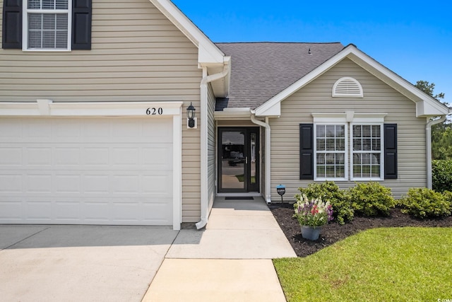 620 Seth Ln, Longs, SC 29568 - traditional-style house featuring concrete driveway, roof with shingles, and a front lawn