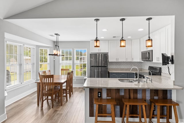 620 Seth Ln, Longs, SC 29568 - kitchen with appliances with stainless steel finishes, a sink, light stone countertops, a peninsula, and baseboards