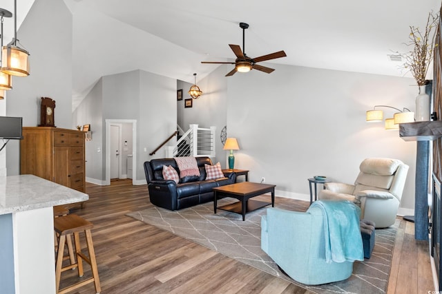 620 Seth Ln, Longs, SC 29568 - living room featuring stairs, wood finished floors, a ceiling fan, baseboards, and high vaulted ceiling